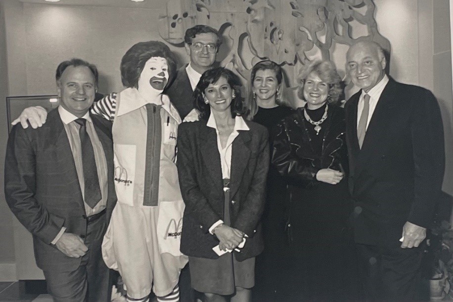 Linda Howell at the Ronald McDonald San Francisco House Opening in 1989: Black and white photo of a group including Ronald McDonald and early RMHC supporters posing together indoors.